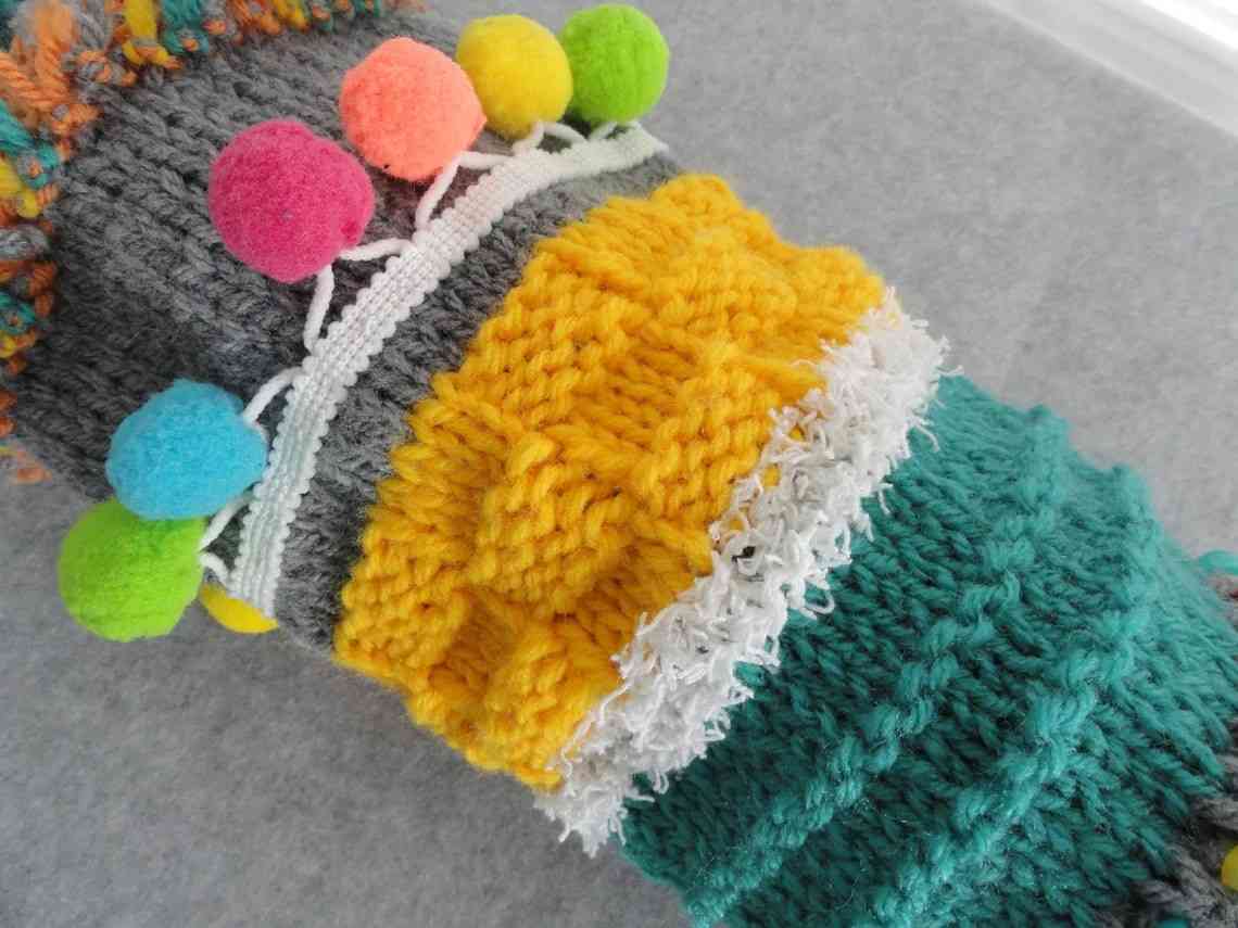 Cozy twiddle muff for ADHD sensory needs with fuzzy balls and various textures.