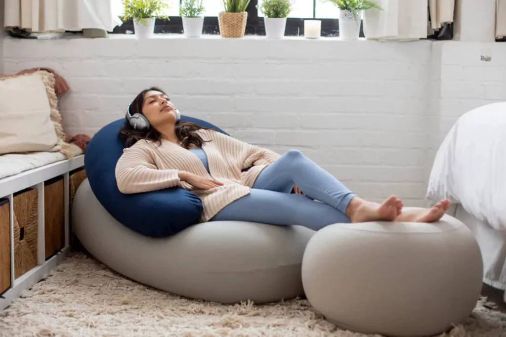 Moon Pod sensory chair -- woman relaxing and wearing headphones.