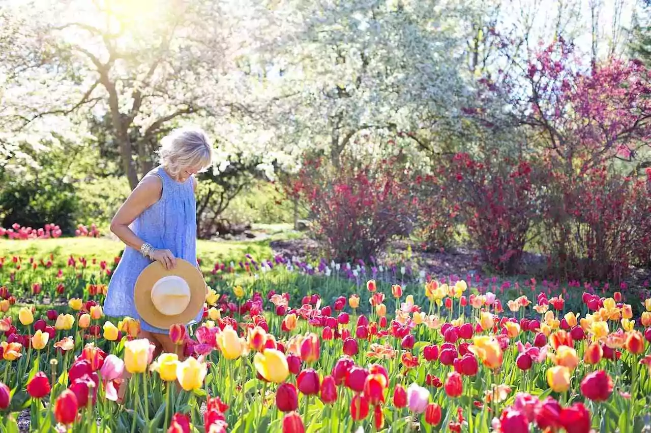 Coping with dyspraxia and sensory processing issues. Woman walking through a field of tulips.
