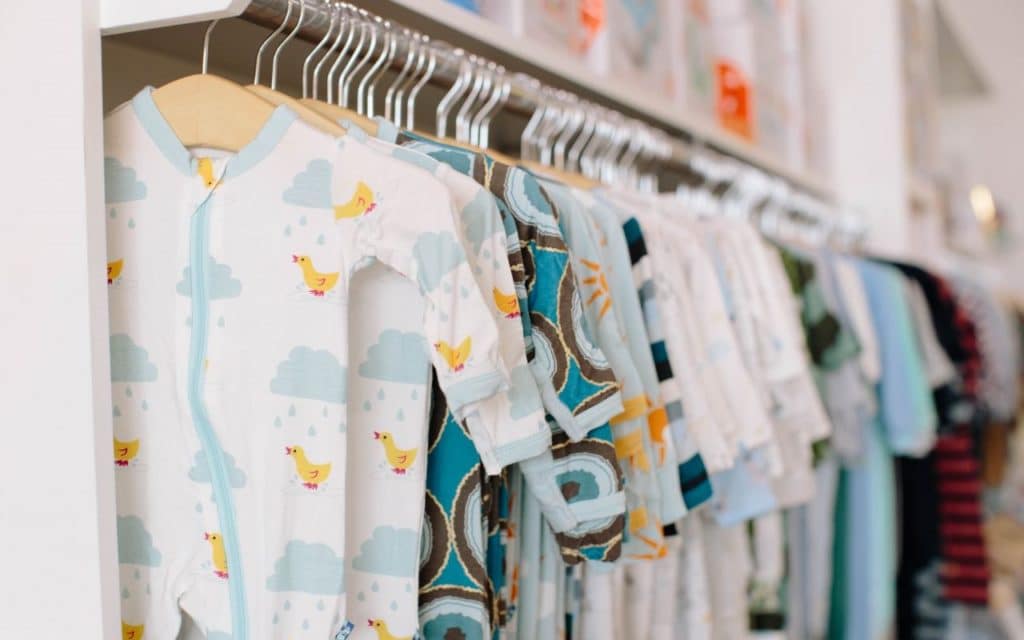 A closet filled with colorful baby clothes.