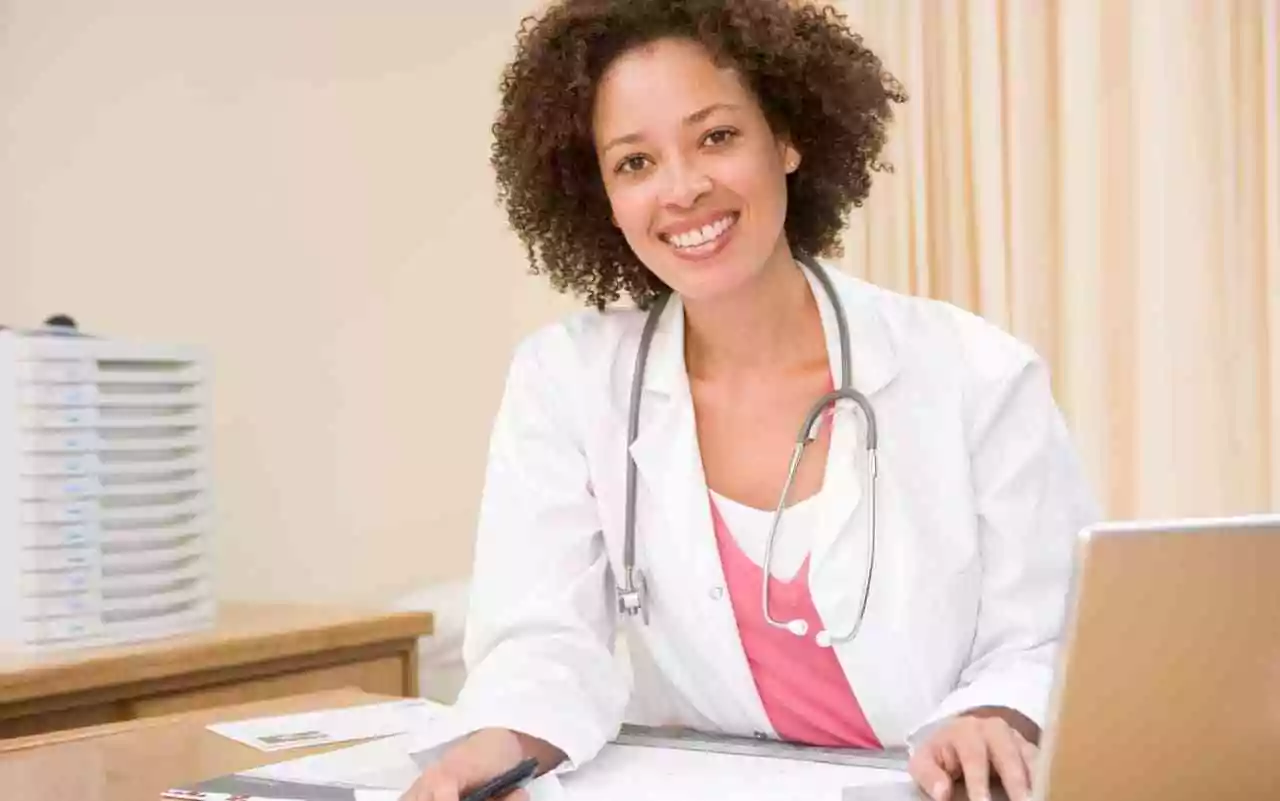 Doctors with disabilities. Black female doctor sitting at a desk.