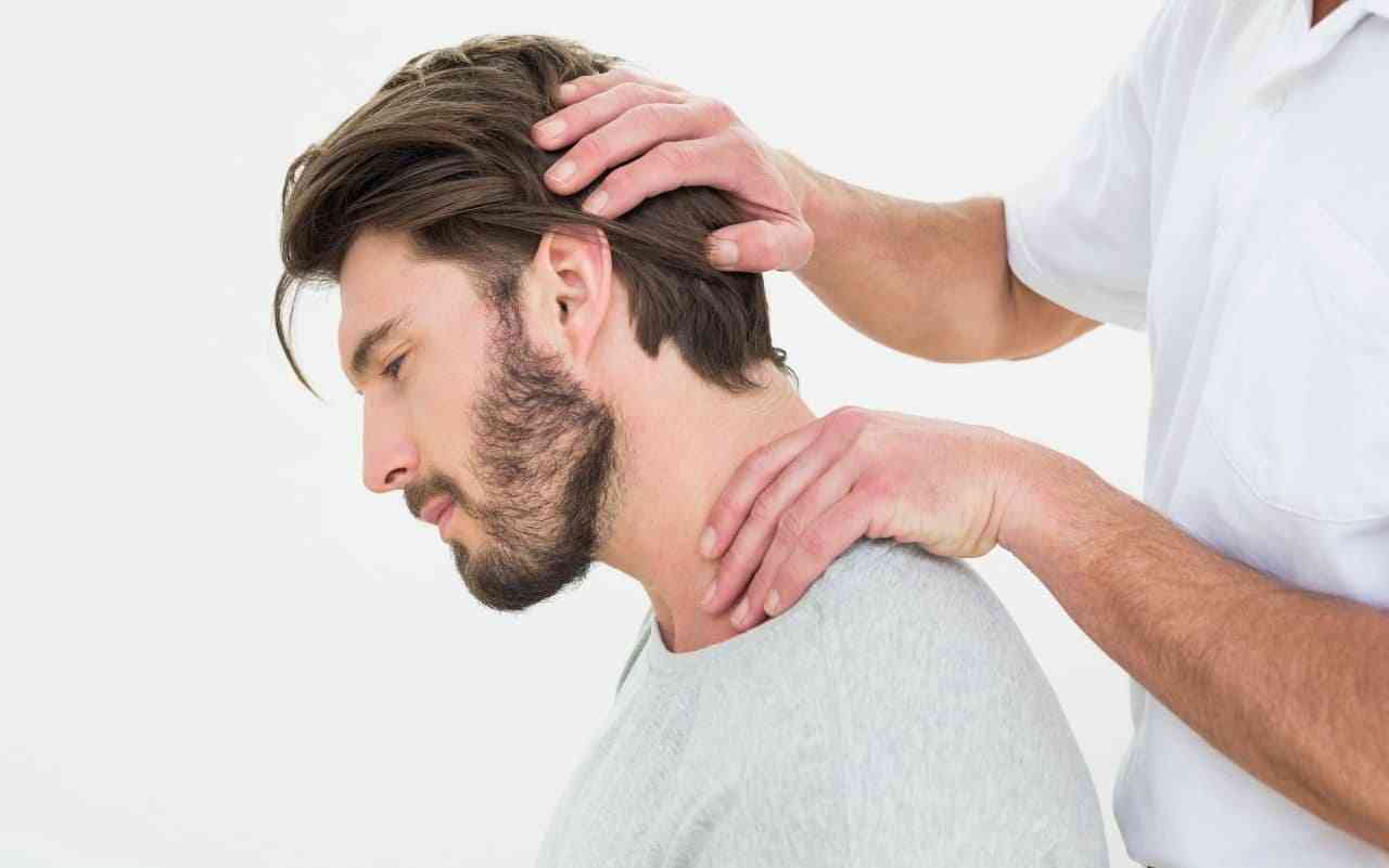 Man receiving chiropractic treatment for migraine prevention.