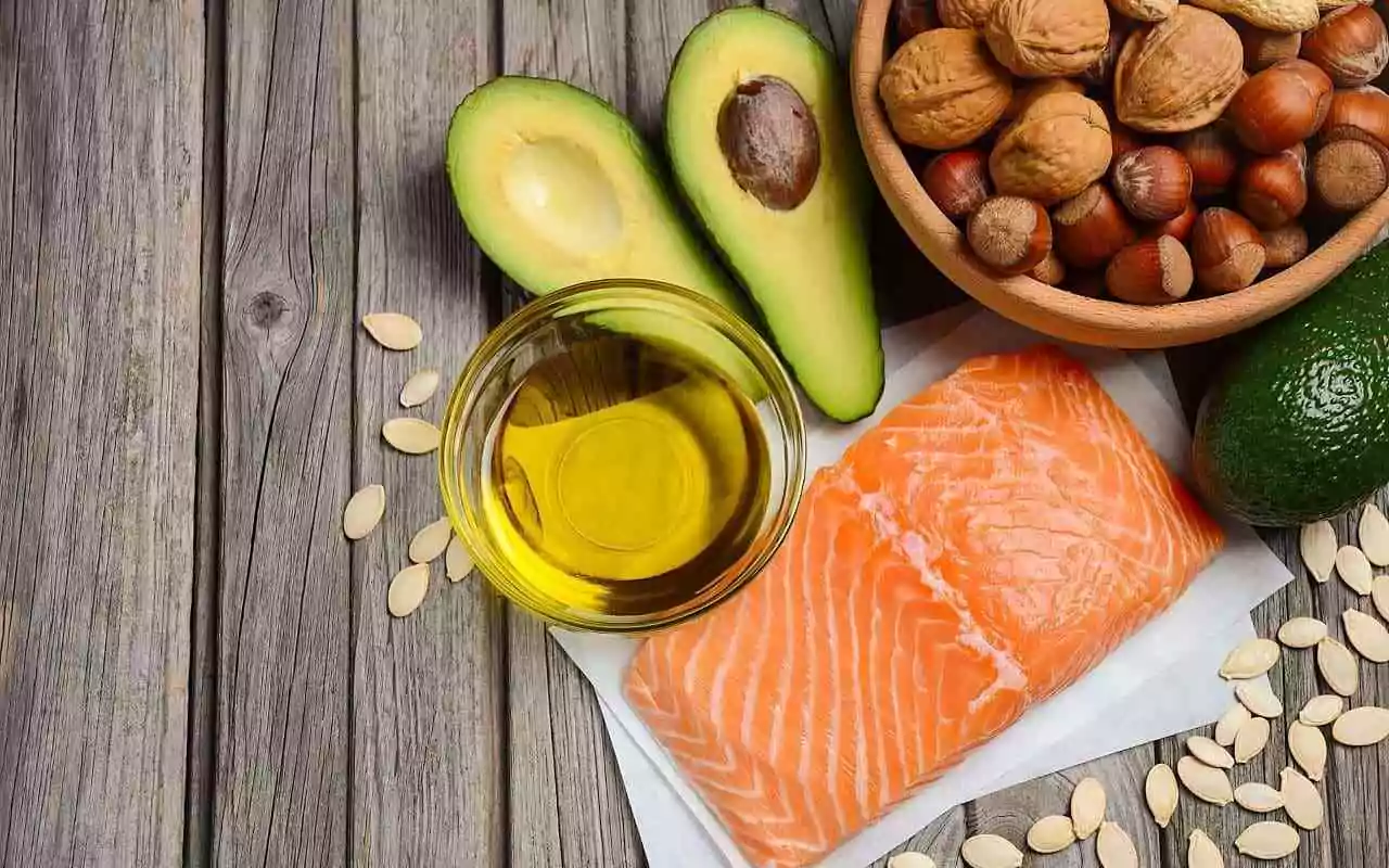 Omega-3 fatty acids for men's health: foods including salmon, olive oil, avocado.