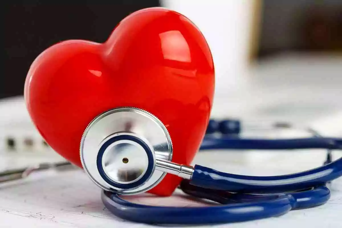 Cardiovascular disease prevention tips. Stethoscope and plastic heart on table.