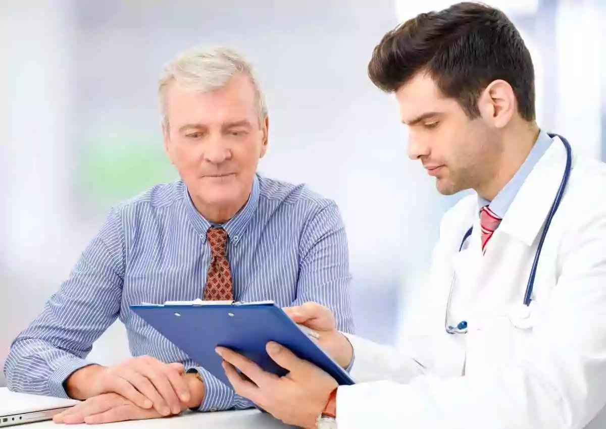 Men's health and prostate condition symptoms. Older man speaking to doctor.