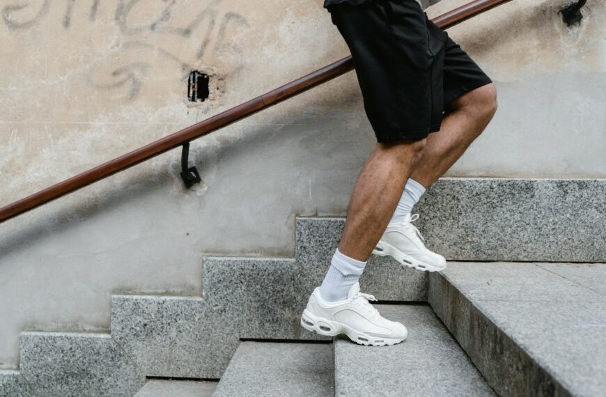 Small steps to fine-tune your mental health recovery. A man in running shoes climbing stairs.