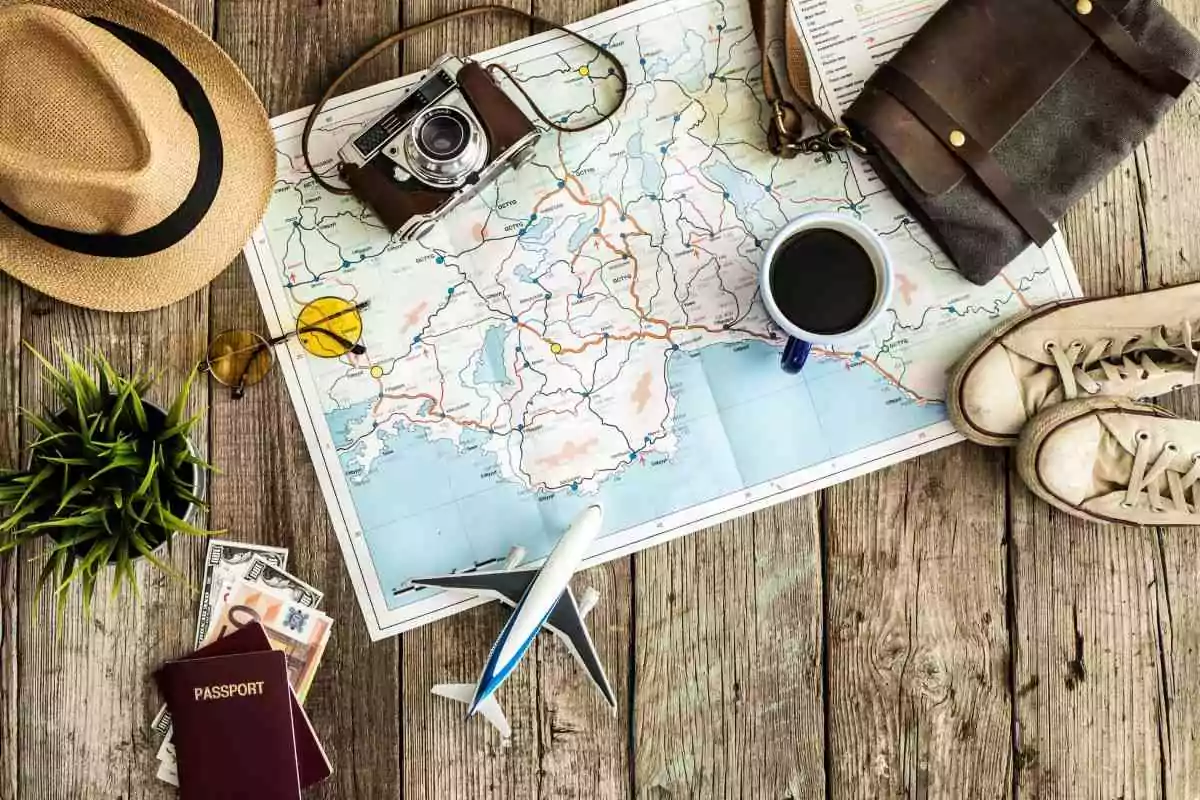 Tips for travelers with disabilities -- image of map with camera, hat, coffee cup, and model plane.