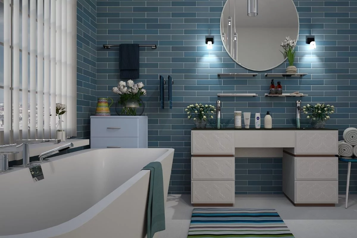 Sensory-friendly bathroom design guide. Luxurious bathtub and soothing blue tile wall.