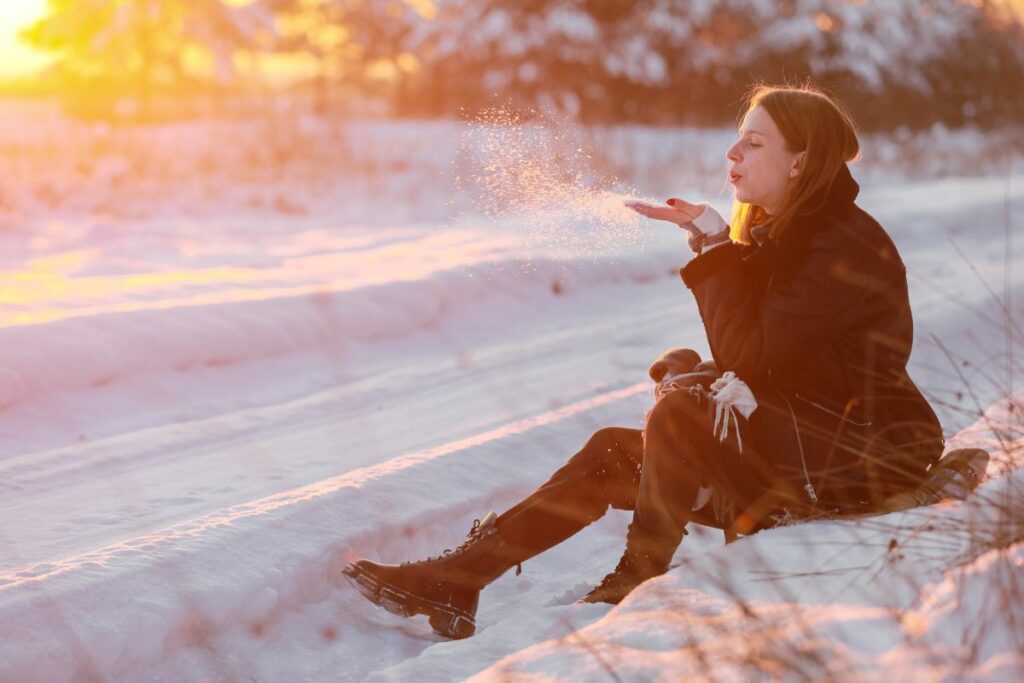Woman with a chronic illness spending time outside with snow.