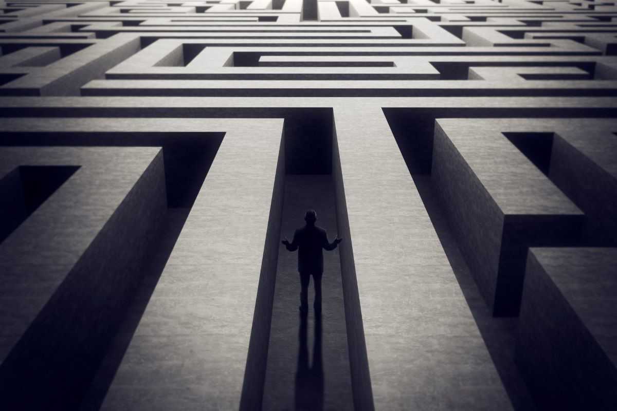 Man navigating a labyrinth of mental illness struggles.
