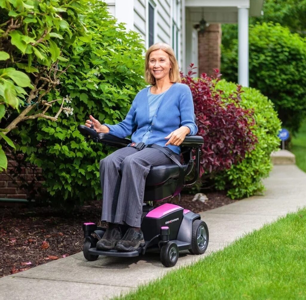 Woman using a Pride Go electric wheelchair.