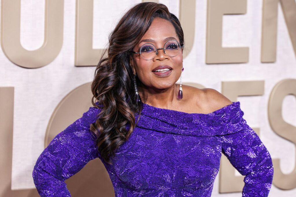 Oprah Winfrey wearing a purple designer gown.